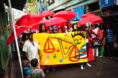 march through streets of Kolkata carrying banner with slogan "pepfar kills sex workers"